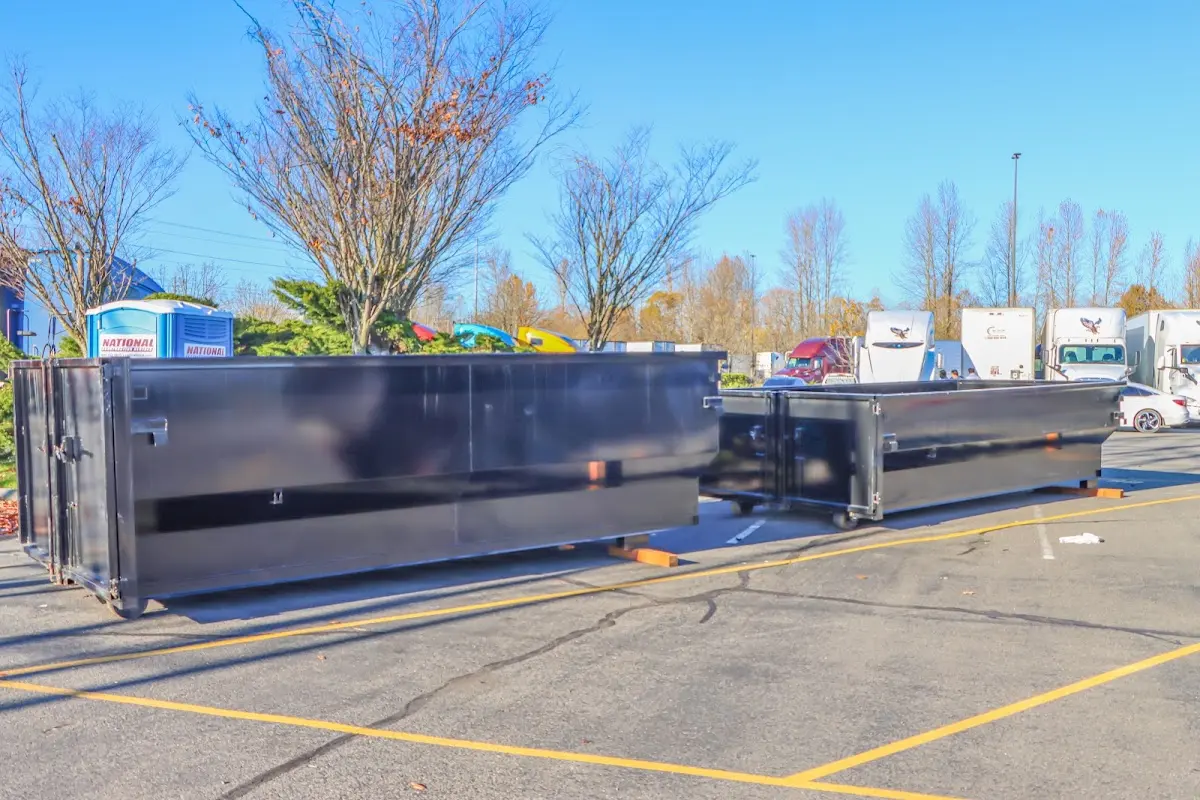 Professional dumpster rental service with roll-off container on residential driveway in Nederland